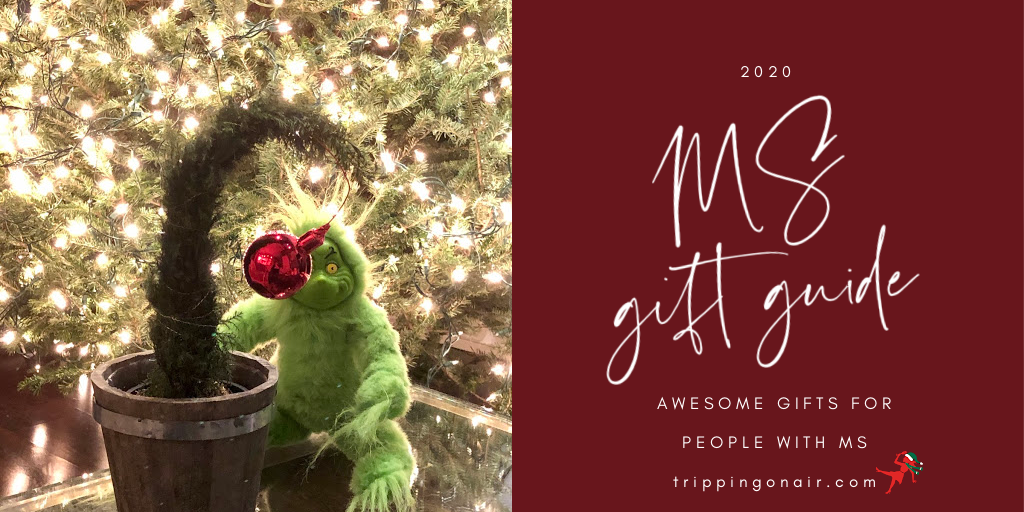 The Grinch sits in front of a well-lit Christmas tree. There is text on a red background that reads: 2020 MS gift guide: awesome gifts for people with MS TrippingOnAir.Com
